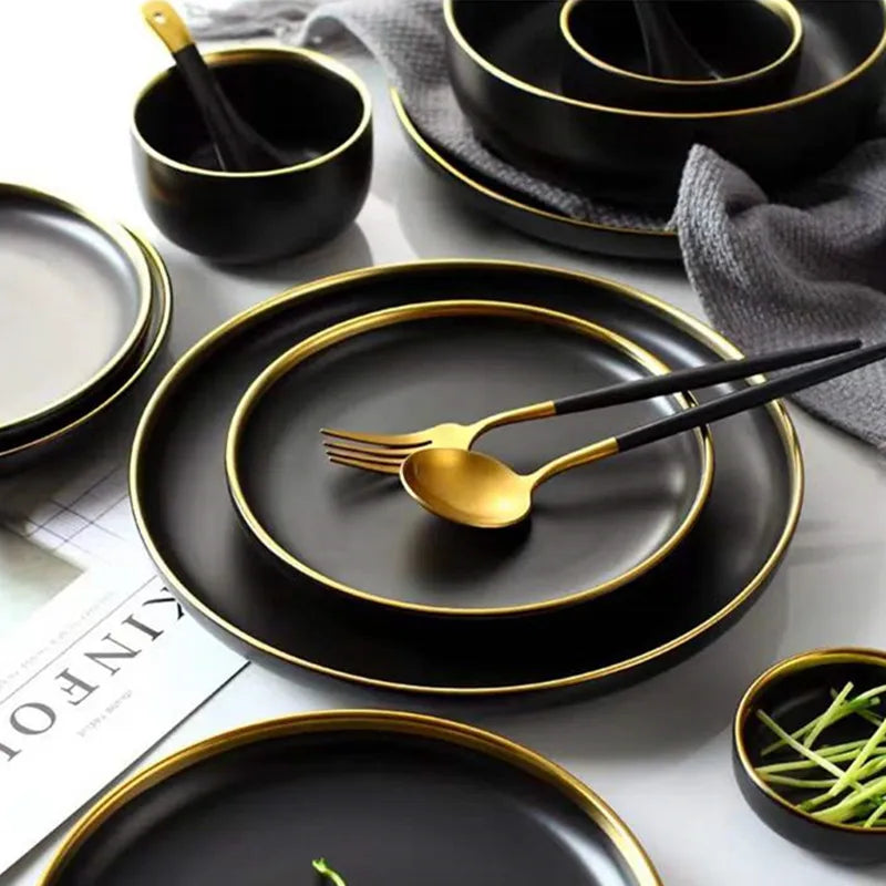"Close-up view of black porcelain plates and bowls with matching cutlery."