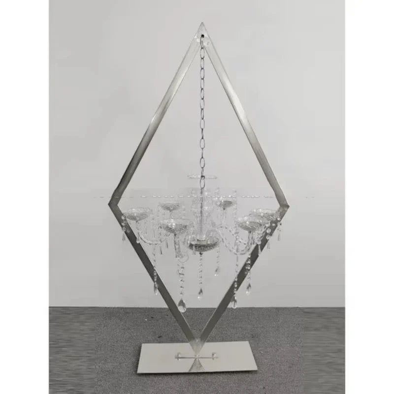 Detailed view of metal candelabra with acrylic candle holders and floral arrangements."