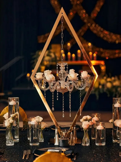  "Elegant event hall featuring metal and acrylic candelabra centerpieces on dining tables."