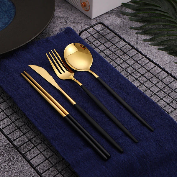 12-piece black and gold stainless steel cutlery set displayed in an open gift box."