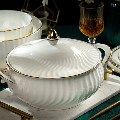 Luxury hand-drawn gold dinnerware set displayed on a dining table