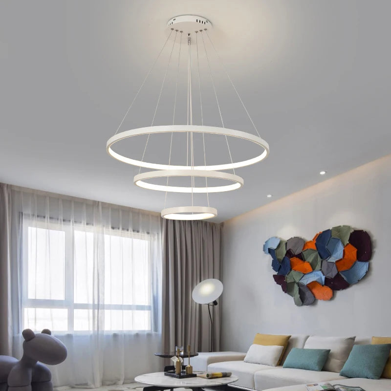 "Elegant dining room featuring the modern LED iron chandelier with four rings."