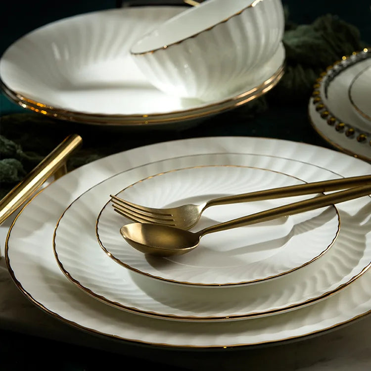 Close-up of golden detail on modern ceramic plates

