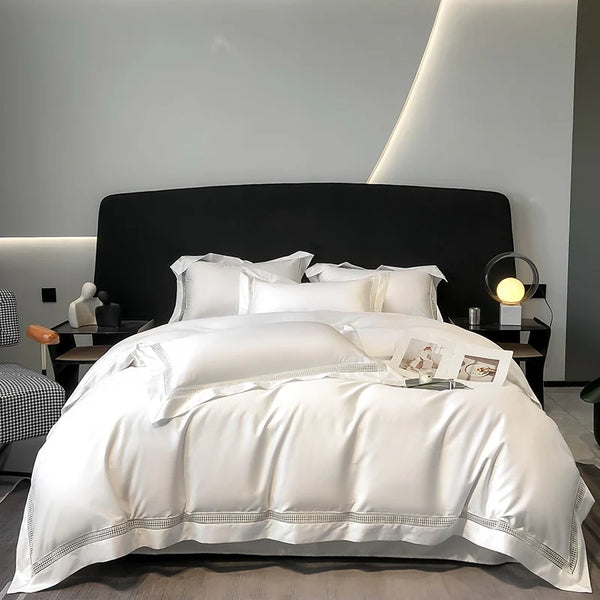 "White 1000TC Egyptian cotton bedding set displayed on a bed with decorative pillows."