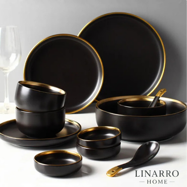  "Black porcelain dinnerware set with cutlery displayed on a dining table."