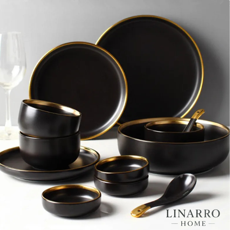  "Black porcelain dinnerware set with cutlery displayed on a dining table."
